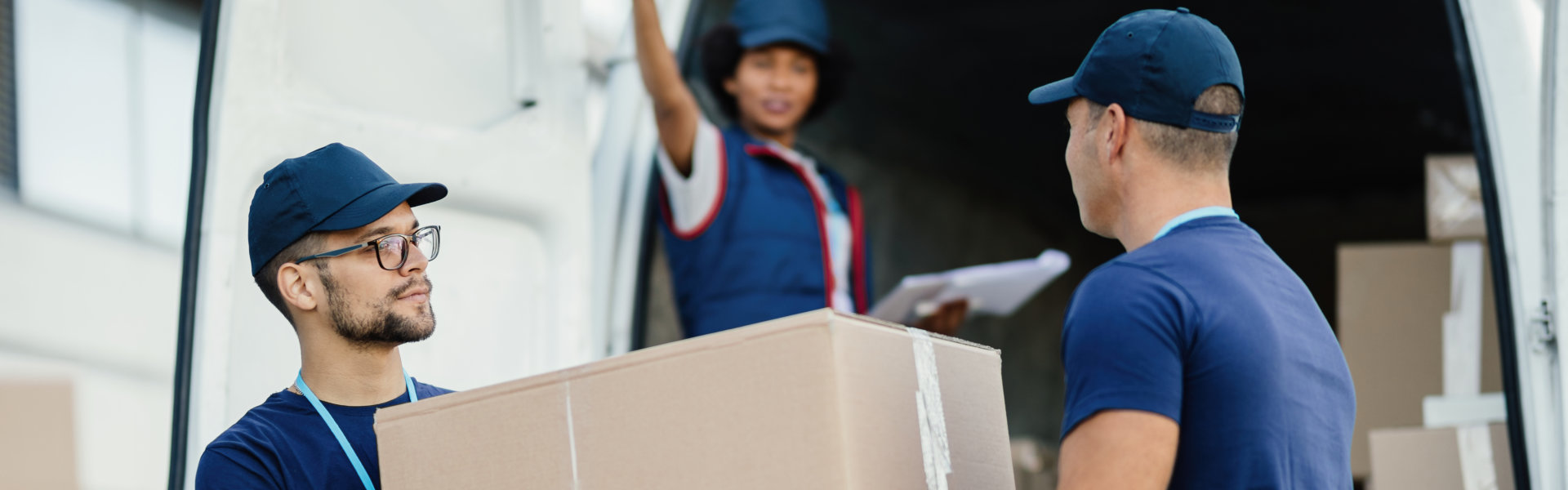two person carying a package